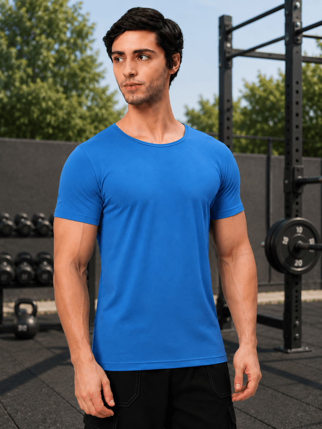 BEDROCK FIT REGULAR FIT T-SHIRT ROYAL BLUE worn by a model in a gym setting with weights in the background.