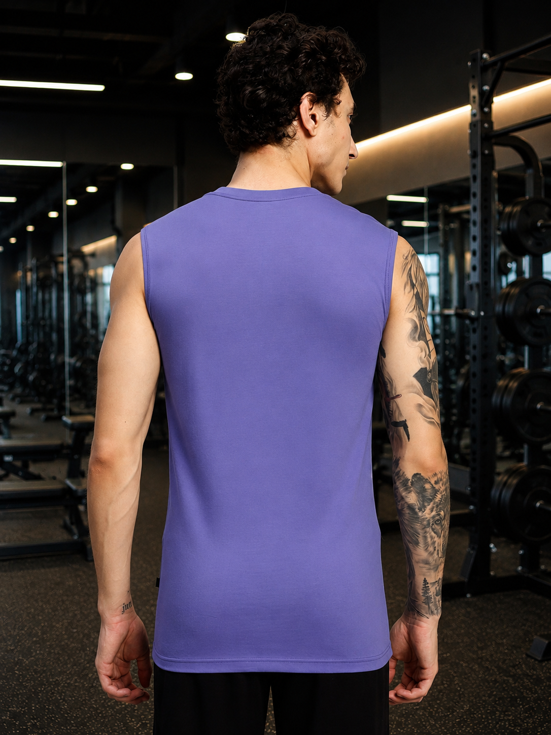 LEVELUP GAMER SLEEVELESS T-SHIRT PURPLE worn by a man in a gym setting, showcasing the back design.