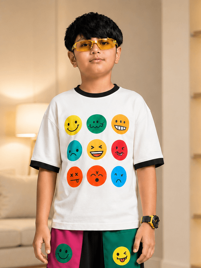 EMOJI VIBES T-SHIRT FOR BOYS GIRL WHITE worn by a boy with playful emoji graphics, styled with casual sunglasses.