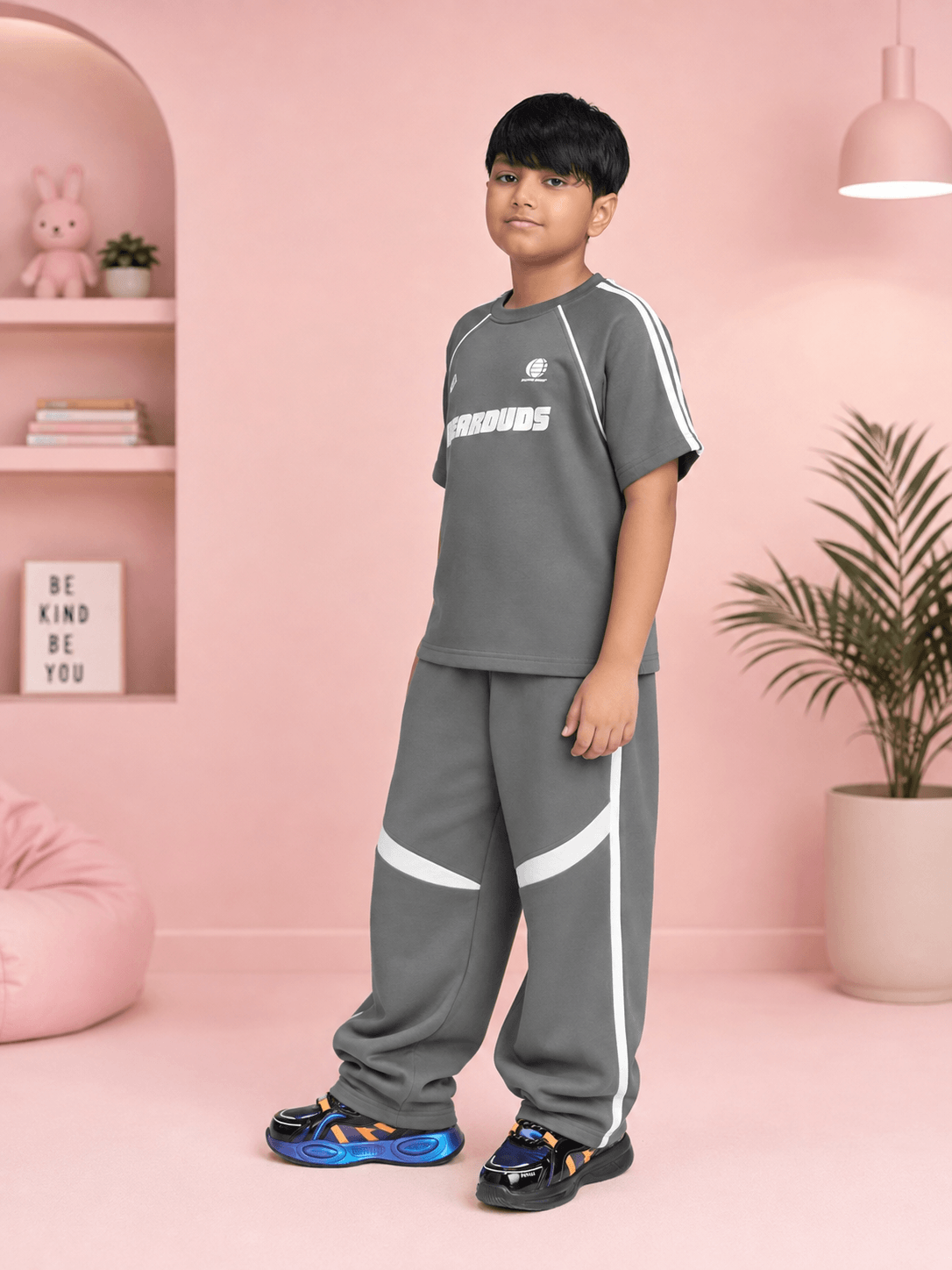 KIDS ROSTER CO-ORD BOYS GIRLS GREY WHITE in a modern kids' fashion set worn by a boy standing against a pink background.
