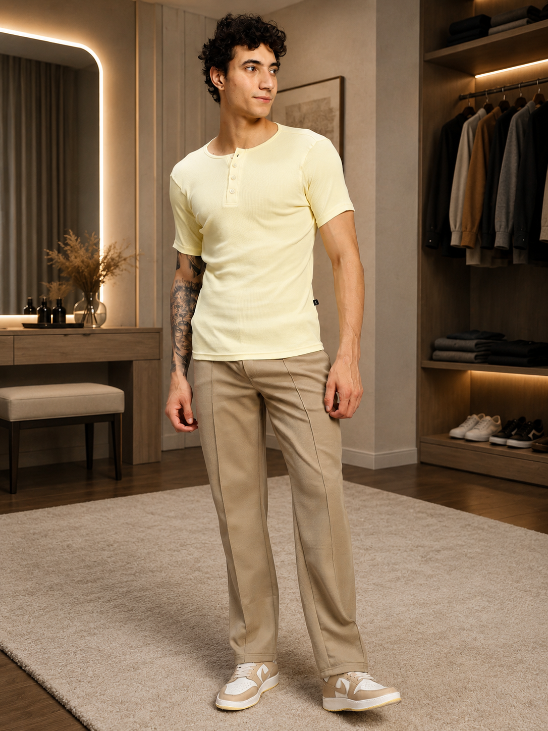 Man wearing ELITE TEXTURED FIT JOGGERS BEIGE and a yellow shirt in a contemporary indoor setting.