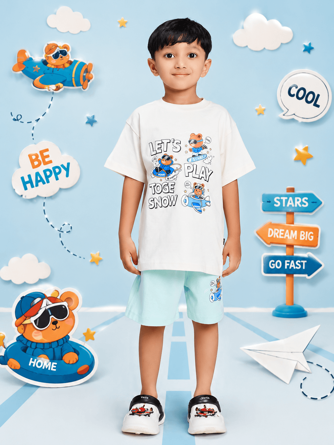CARTOON BEAR CO-ORD SET FOR BOYS AND GIRLS WHITE MINT GREEN worn by a smiling boy in a playful environment.