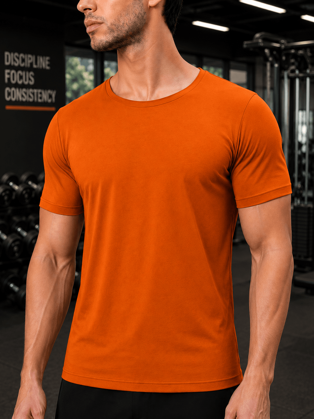 BEDROCK FIT REGULAR FIT T-SHIRT ORANGE worn by a model in a gym setting, showcasing its vibrant color.