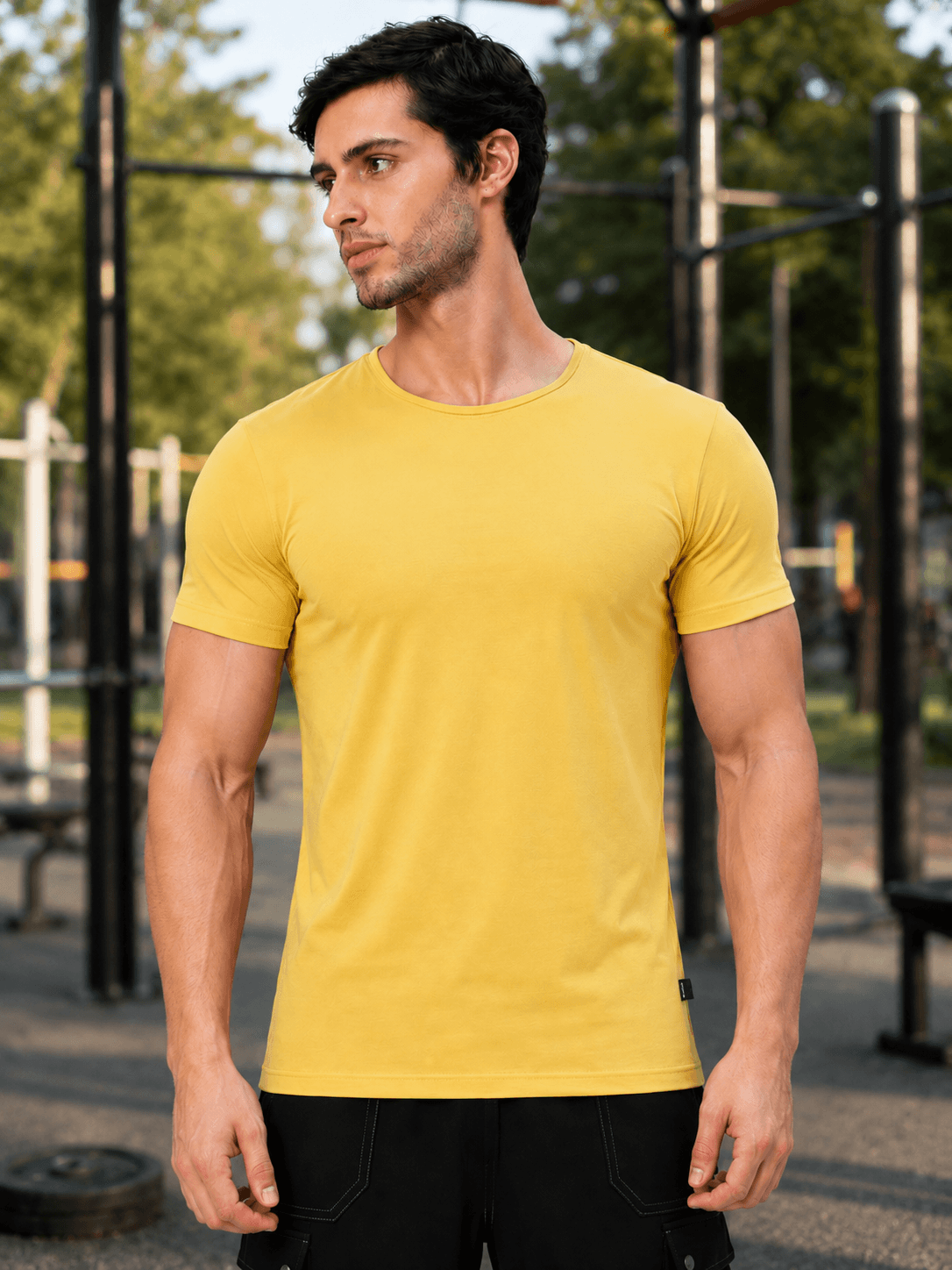 BEDROCK FIT REGULAR FIT T-SHIRT YELLOW worn by a man outdoors, showcasing the vibrant yellow color and fitted design.