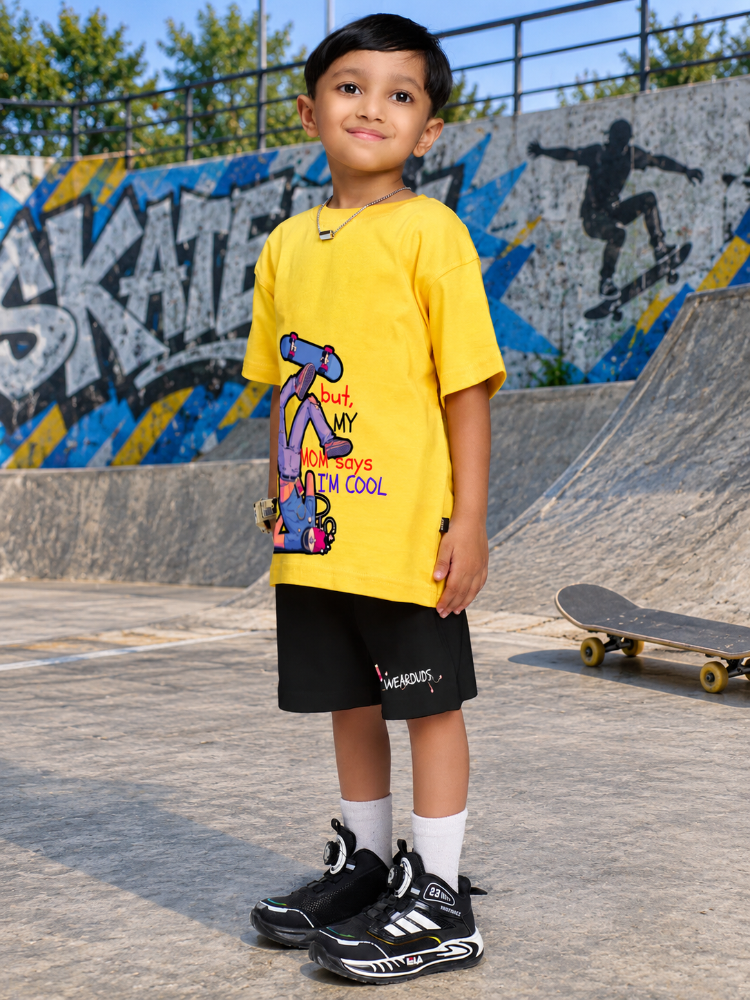 COOL DUDE SKATER CO-ORD FOR BOYS GIRLS BLACK YELLOW BLACK worn by a young boy at a skate park in vibrant yellow and black outfit.