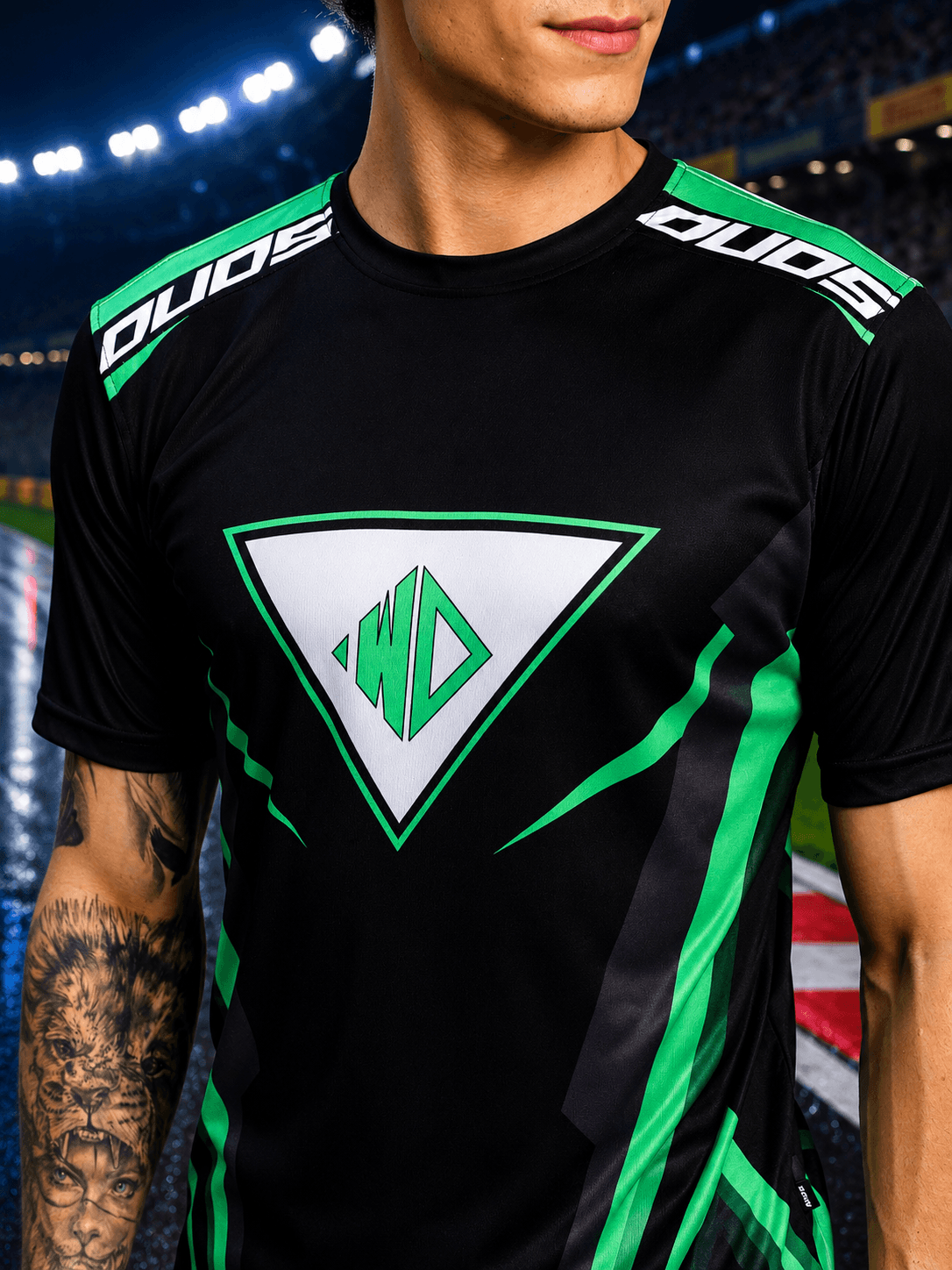 APEX RACING T-SHIRT BLACK on a model in a sports venue, featuring green accents and bold designs.