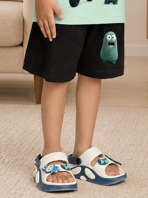 FUN MONSTER GRAPHIC SHORTS FOR BOYS GIRLS BLACK worn by child in playful styling with monster graphic and fun sandals.