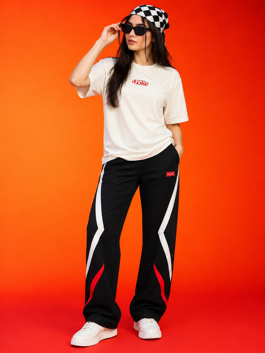 WOMEN METROPOLITAN JOGGERS BLACK WHITE RED STRIPE worn with a stylish T-shirt and checkered headband on a vibrant background.