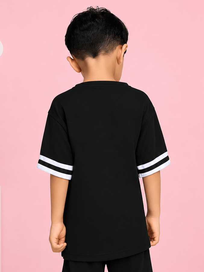 Boy wearing MASCOT GRAPHIC T-SHIRT FOR BOYS GIRLS BLACK WHITE, showing back view with sporty stripes.