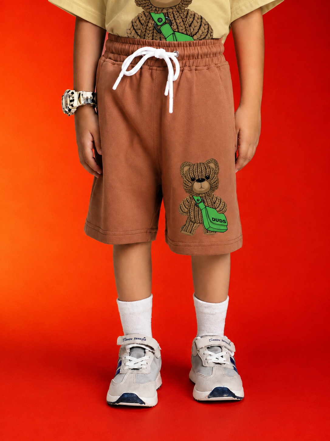 LITTLE EXPLORER TEDDY CO-ORD FOR BOYS GIRLS BEIGE BROWN featuring a child wearing cozy brown shorts with a teddy bear design.