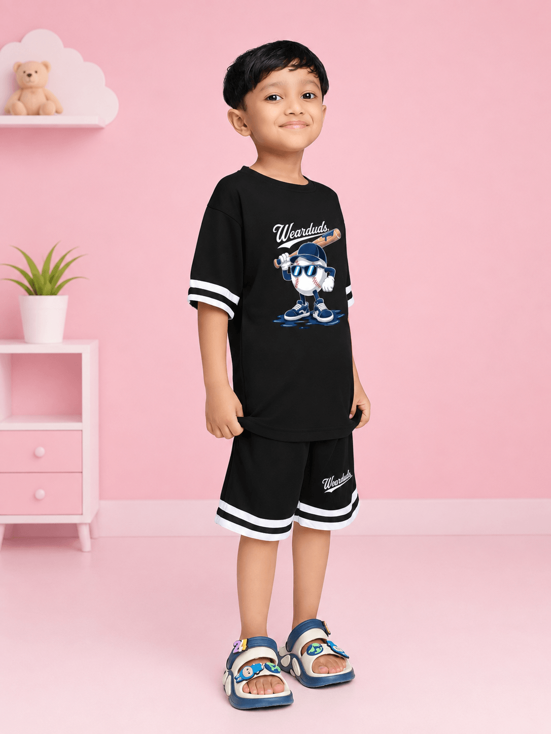 MASCOT GRAPHIC CO-ORD SET FOR BOYS GIRLS BLACK WHITE worn by a boy, showcasing playful style in a black and white outfit.