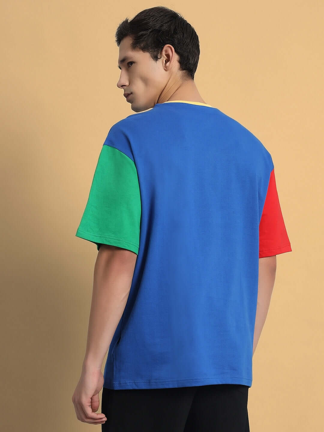 Back view of FINLEY Color Blocked Oversized T-Shirt in blue, green, and red, made from premium cotton. Stylish and comfortable design.