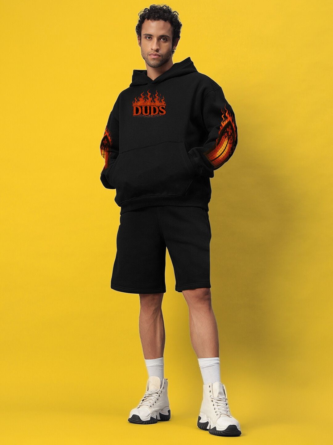 FIRE NEVER KILLS THE LIGHT FLEECE CO-ORD BLACK worn by model, showcasing street-luxe style and cozy fleece in yellow background