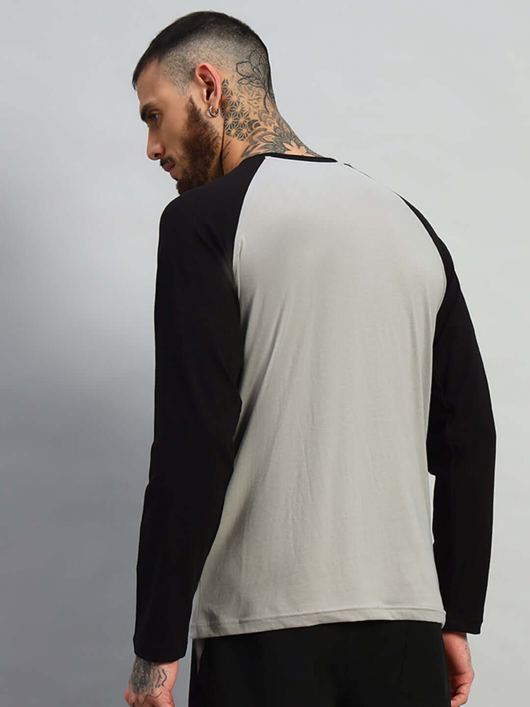 Model wearing black-grey FitFlow slim fit sweatshirt, back view showcasing the premium cotton fabric. Made in India. Wash cold. Bio-washed.