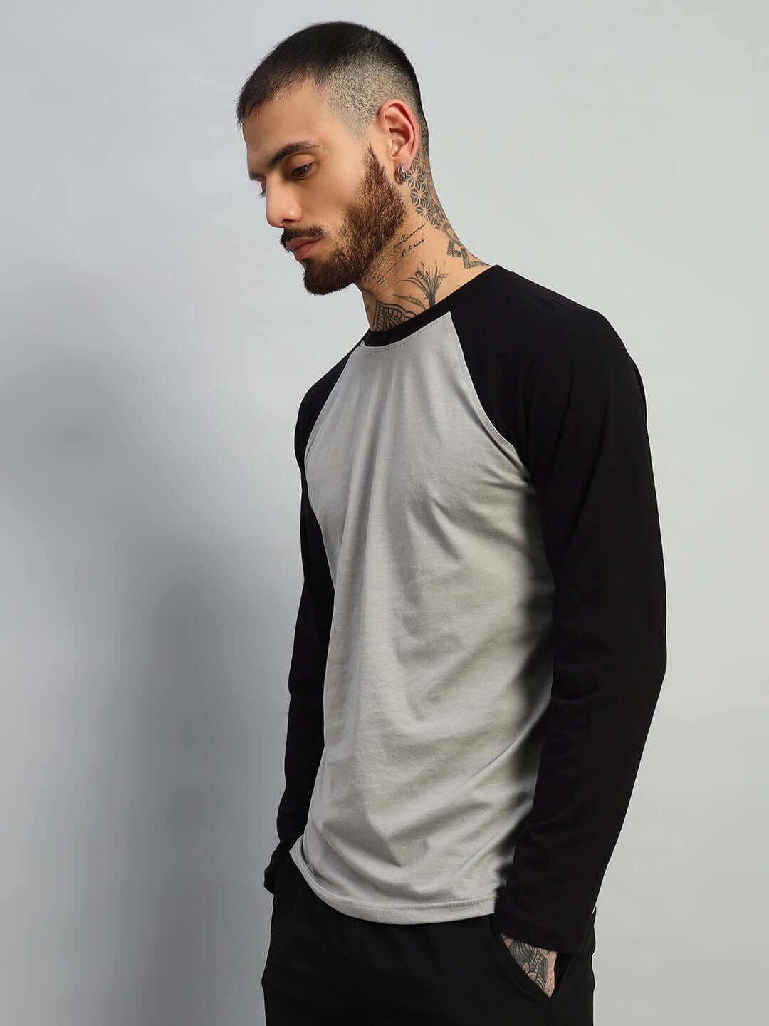 Man wearing Fitflow slim fit sweatshirt in black-grey, made from 100% cotton, shown against a neutral background, ideal for casual wear.