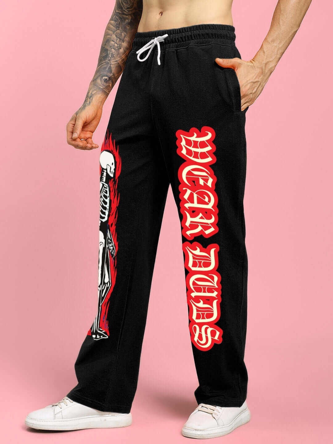 Black relaxed fit jogger featuring a flaming skeleton print and 'WEAR DUDS' lettering, made to order with customizable sizing options.