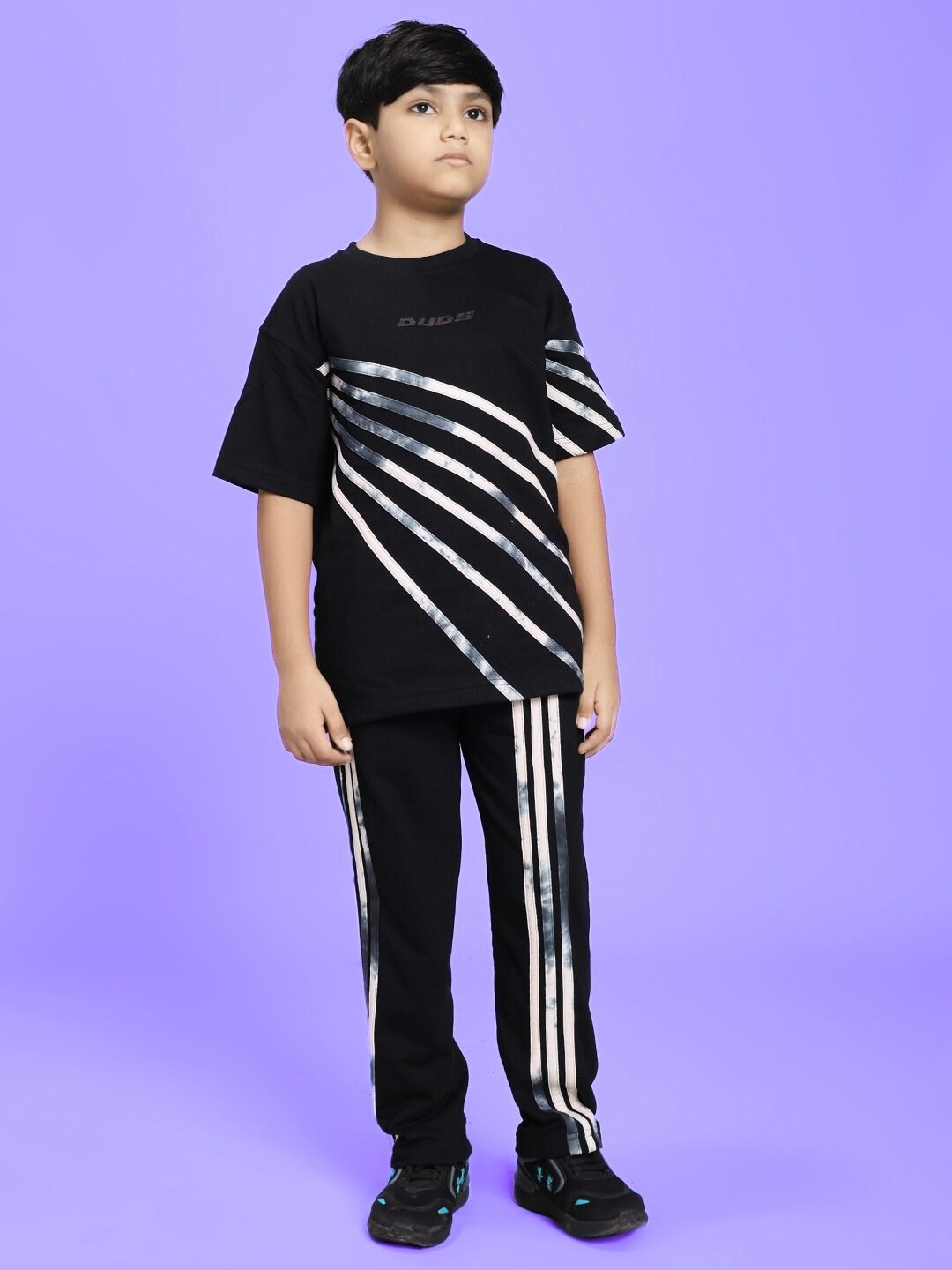 Child wearing FLICKER DESIGNER CO-ORD SET FOR BOYS GIRLS BLACK against a purple background.