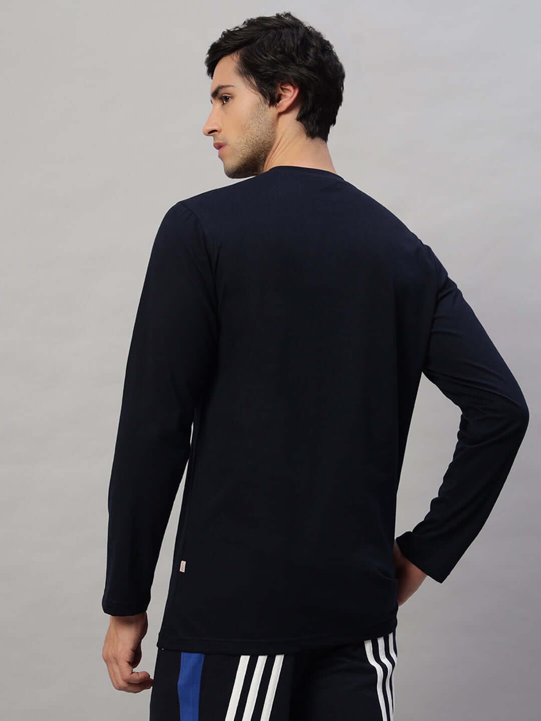 Male model wearing a navy blue FLIMSY SLIM FIT sweatshirt, made from 100% cotton premium heavy gauge fabric, showcasing the back view.