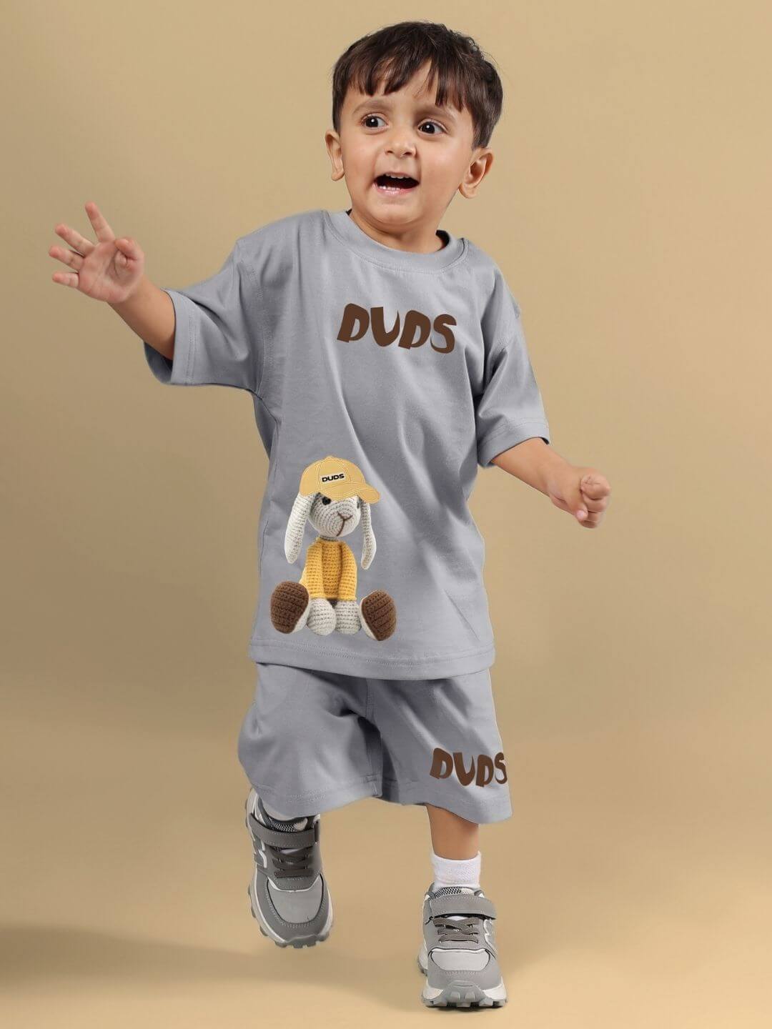 Child wearing FLINT BUNNY CO-ORD FOR BOYS AND GIRLS GREY outfit with bunny design, smiling and playful.