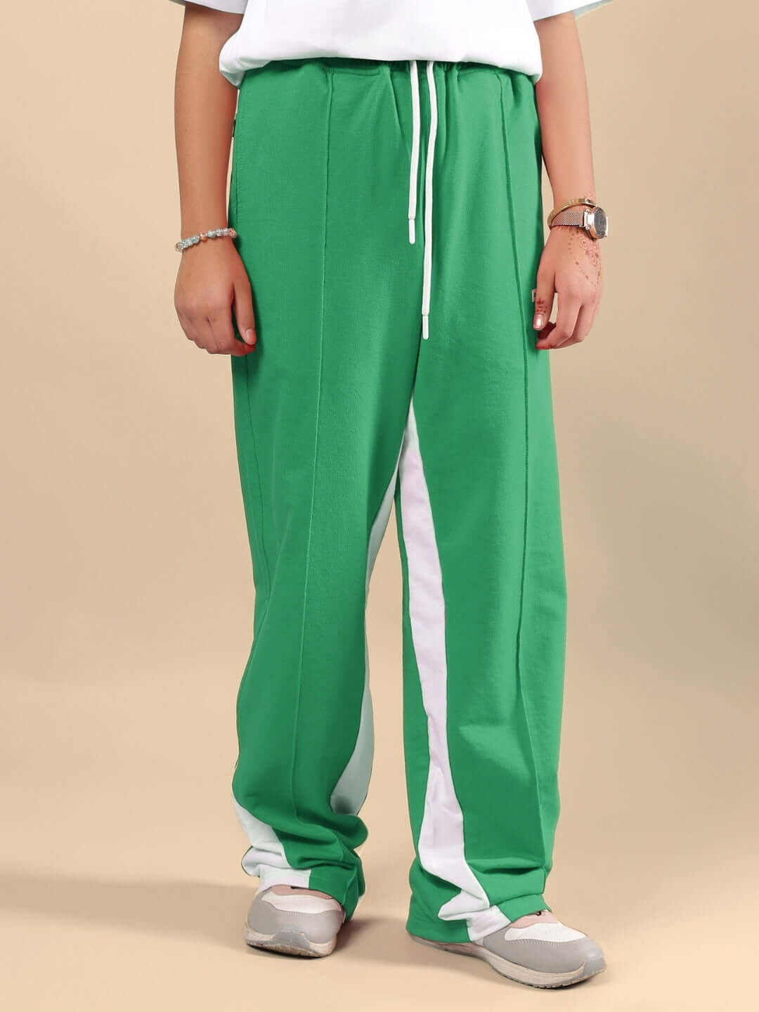 Child wearing FLOPPY JOGGER FOR BOYS & GIRLS GREEN with a white stripe, showcasing comfortable and adjustable custom fit options.