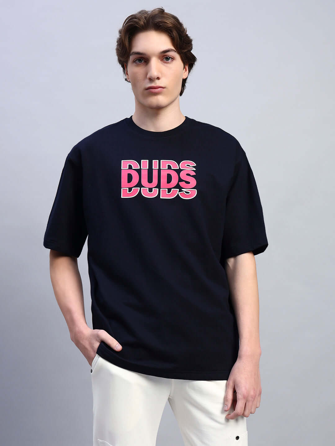 Model wearing navy blue FLORES creative print oversized t-shirt, made from premium cotton and elastane blend, by Color By Colours.
