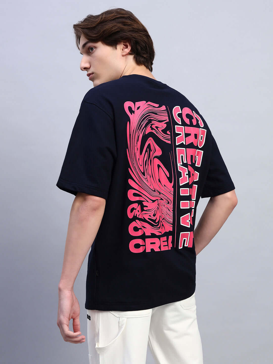 Navy blue oversized T-shirt with creative pink print design, made from premium cotton French terry and elastane. Stylish and comfortable.