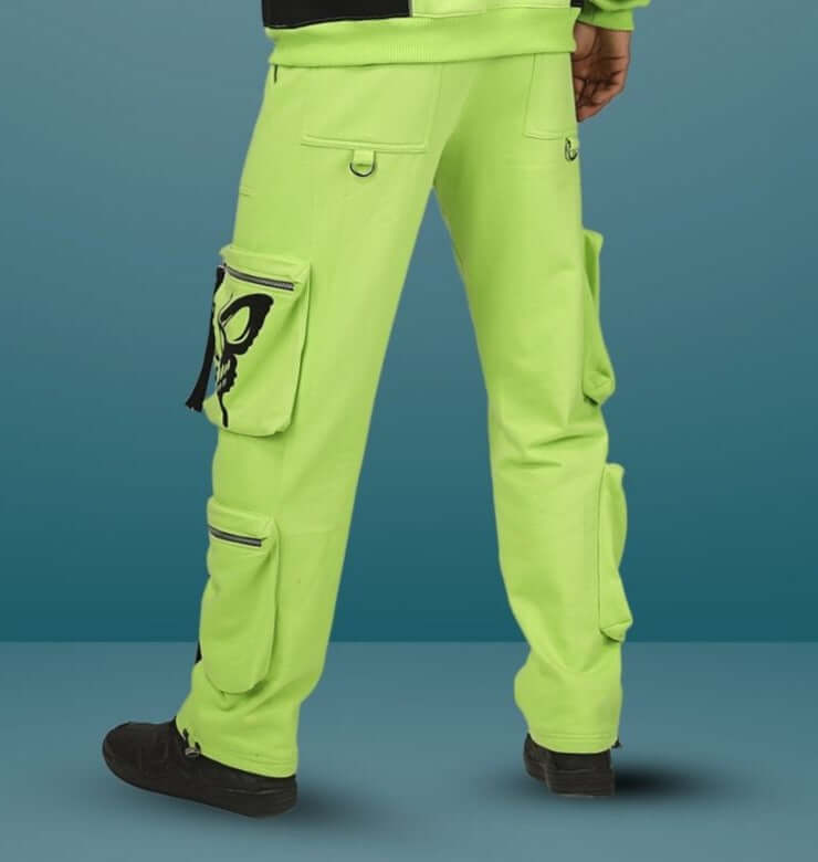 Person wearing fluorescent neon green multi-pocket cargo pants with black sneakers, showcasing stylish and functional design.