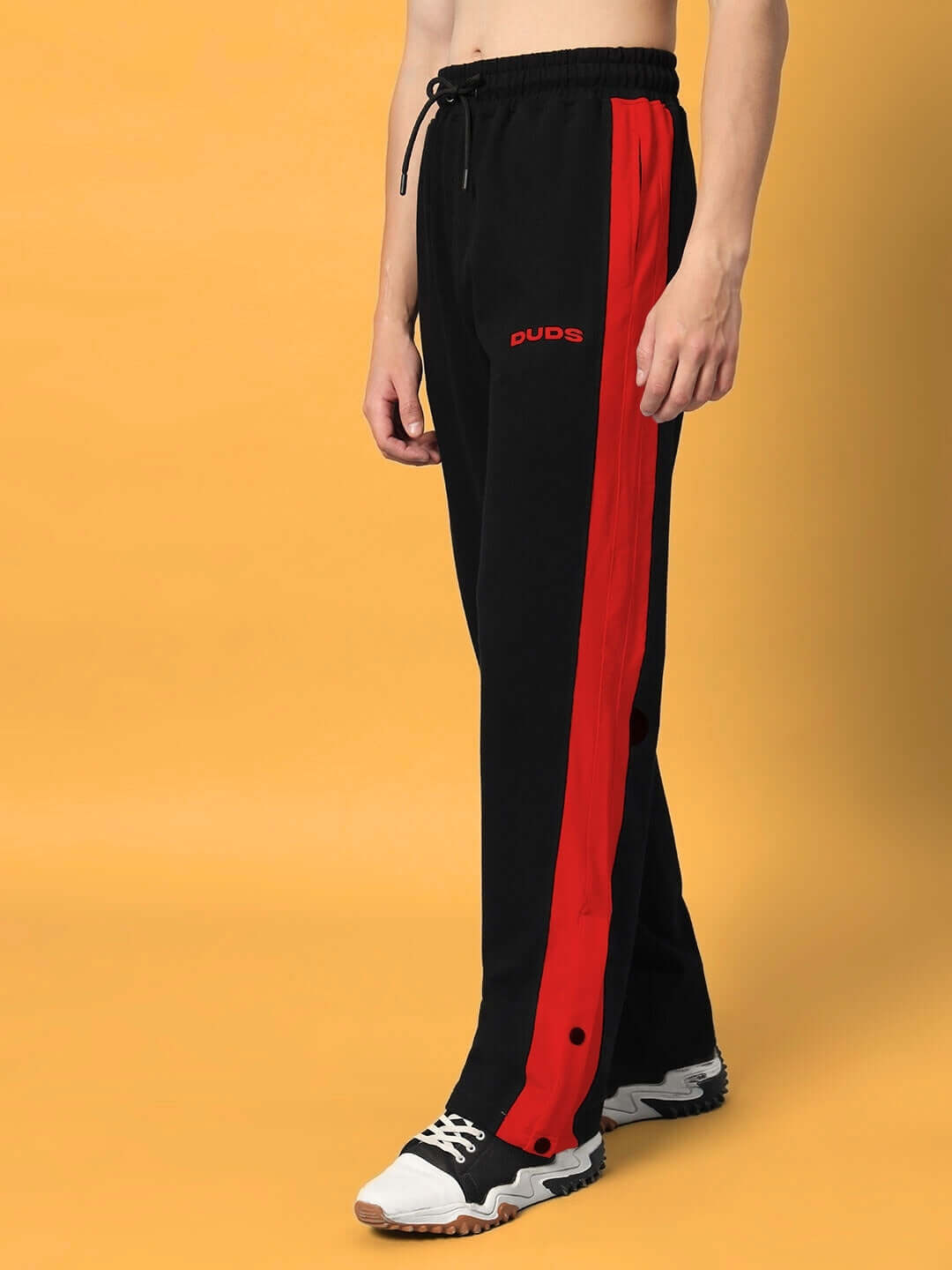 Black and red FLURRY CONTRAST JOGGERS by DUDS, made-to-order with customization options. Comfortable and stylish pants for casual wear.