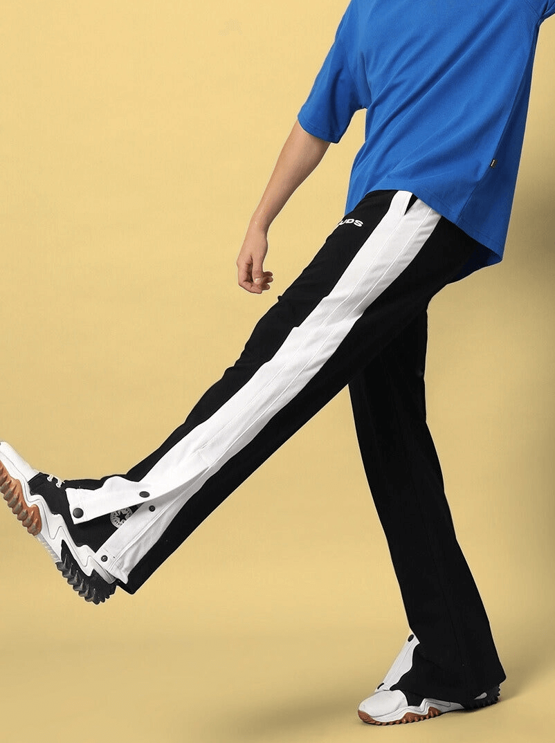Person wearing FLURRY CONTRAST JOGGERS in black and white, styled with sneakers, showcasing street fashion.