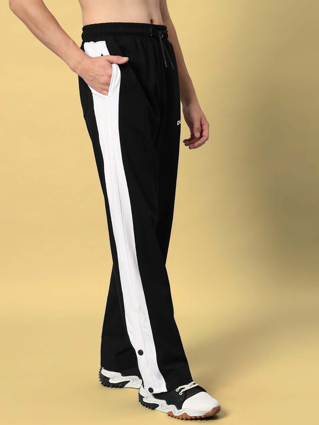 Model wearing FLURRY CONTRAST JOGGERS in black and white, designed for comfort and style by DUDS. Ideal for custom fit options.