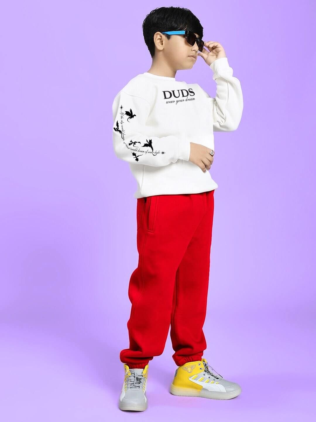 Child modeling FLY OR DIE DRAGON FLEECE CO-ORD FOR BOYS AND GIRLS WHITE RED with trendy sunglasses, showcasing street-style outfit.