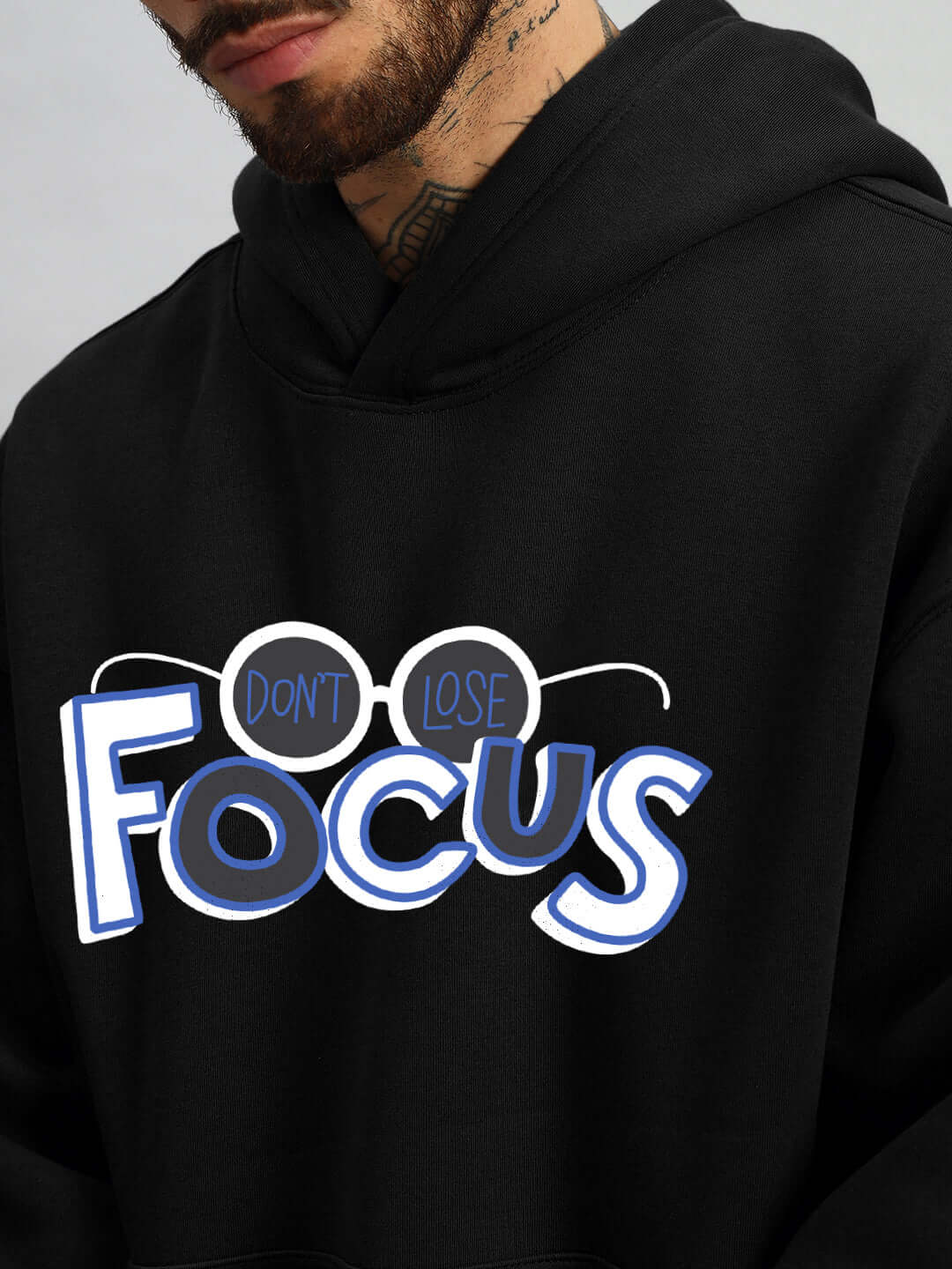 Close-up of WEARDUDS FOCUS FLEECE HOODIE BLACK with "Don't Lose Focus" graphic design