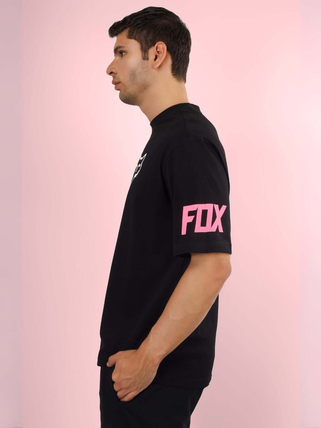 Side view of black FOX oversized t-shirt with pink logo on sleeve, customizable for custom fit orders.