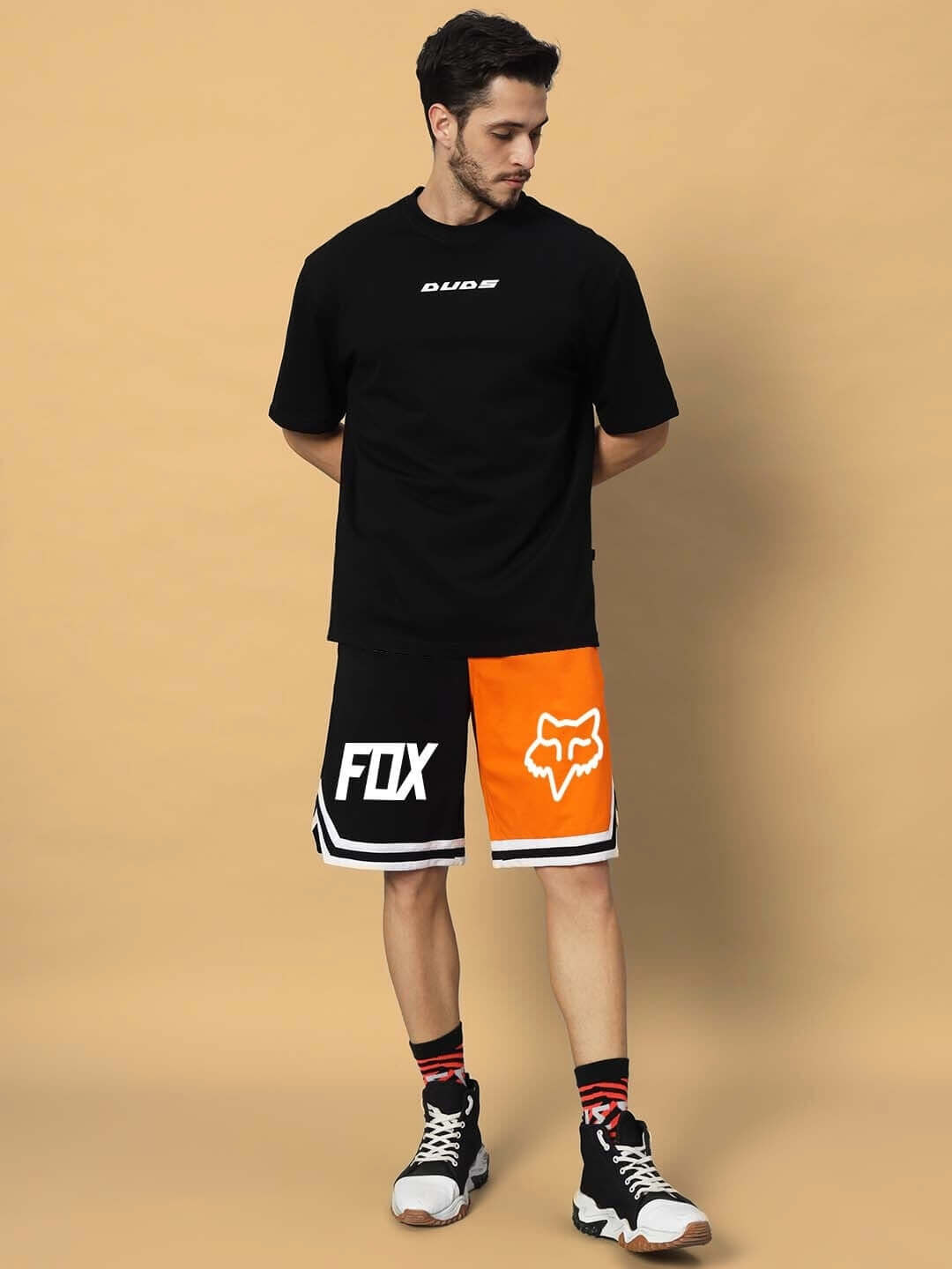 Man wearing FOX regular fit shorts in orange-black with DUDS shirt, showcasing stylish casual apparel for men.