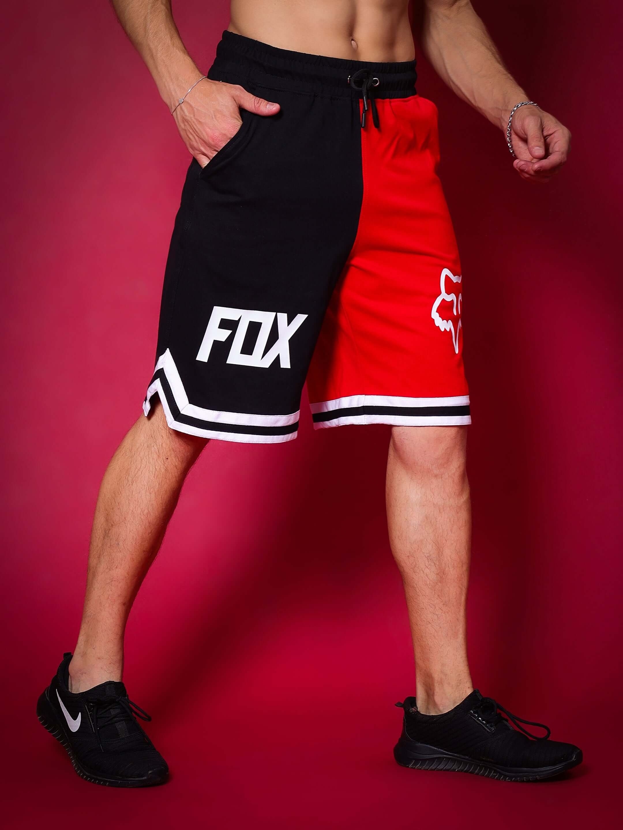 Model wearing FOX regular fit red-black shorts with customizable fit option available for prepaid orders on DUDS.