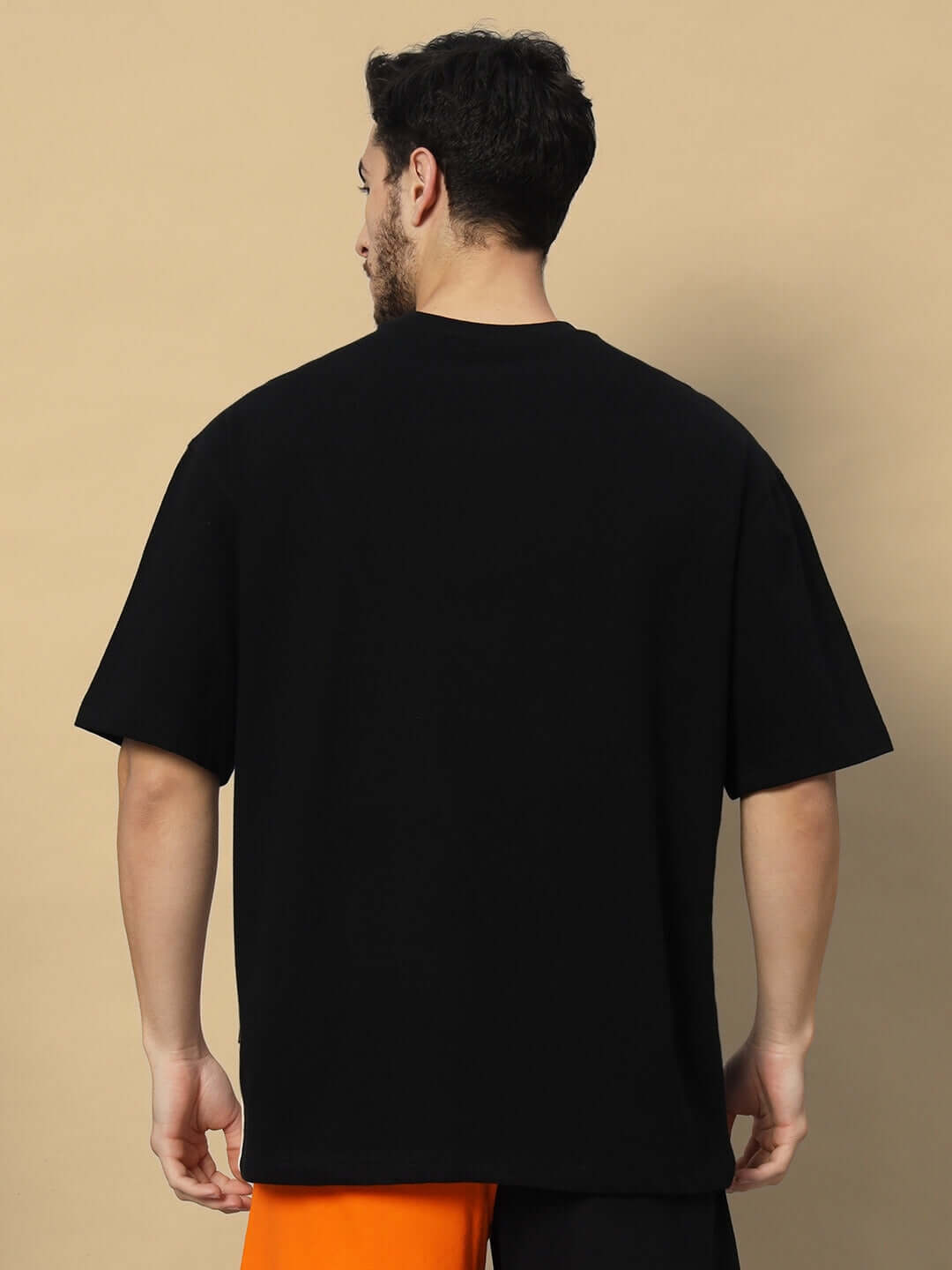 Back view of model wearing Freedom Contrast Oversized Black-White T-shirt made of premium cotton fabric, India.