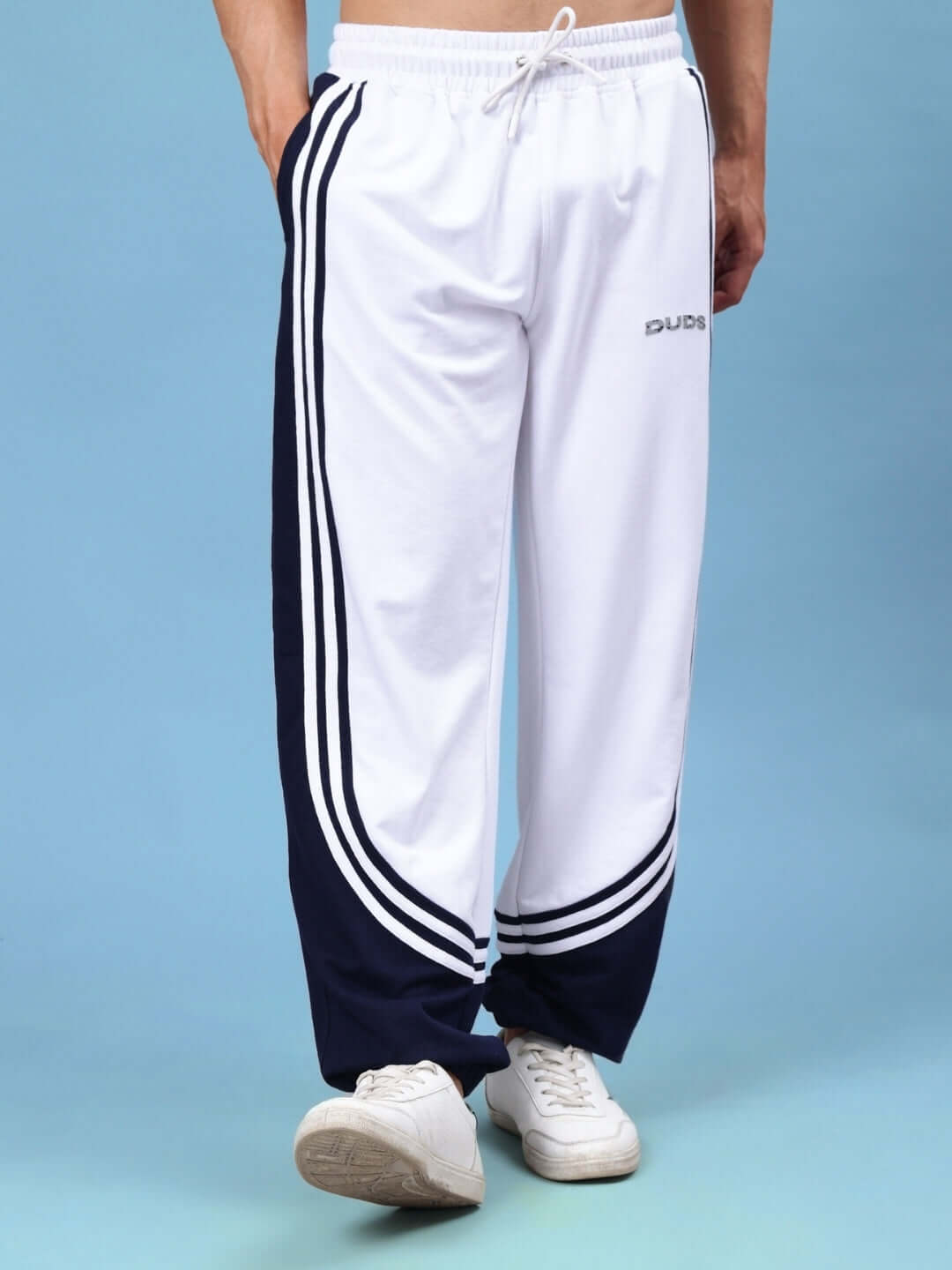 Model wearing Frenzy Curve Contrast Joggers in White-Navy by DUDS, featuring custom sizing and made-to-order craftsmanship for optimal fit.
