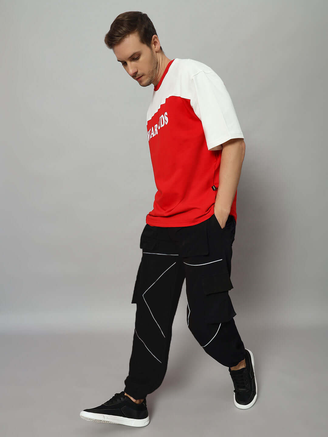 Person wearing FRONTLINE REFLECTOR PARACHUTE CARGO PANT BLACK with reflective accents, styled for trendsetters.