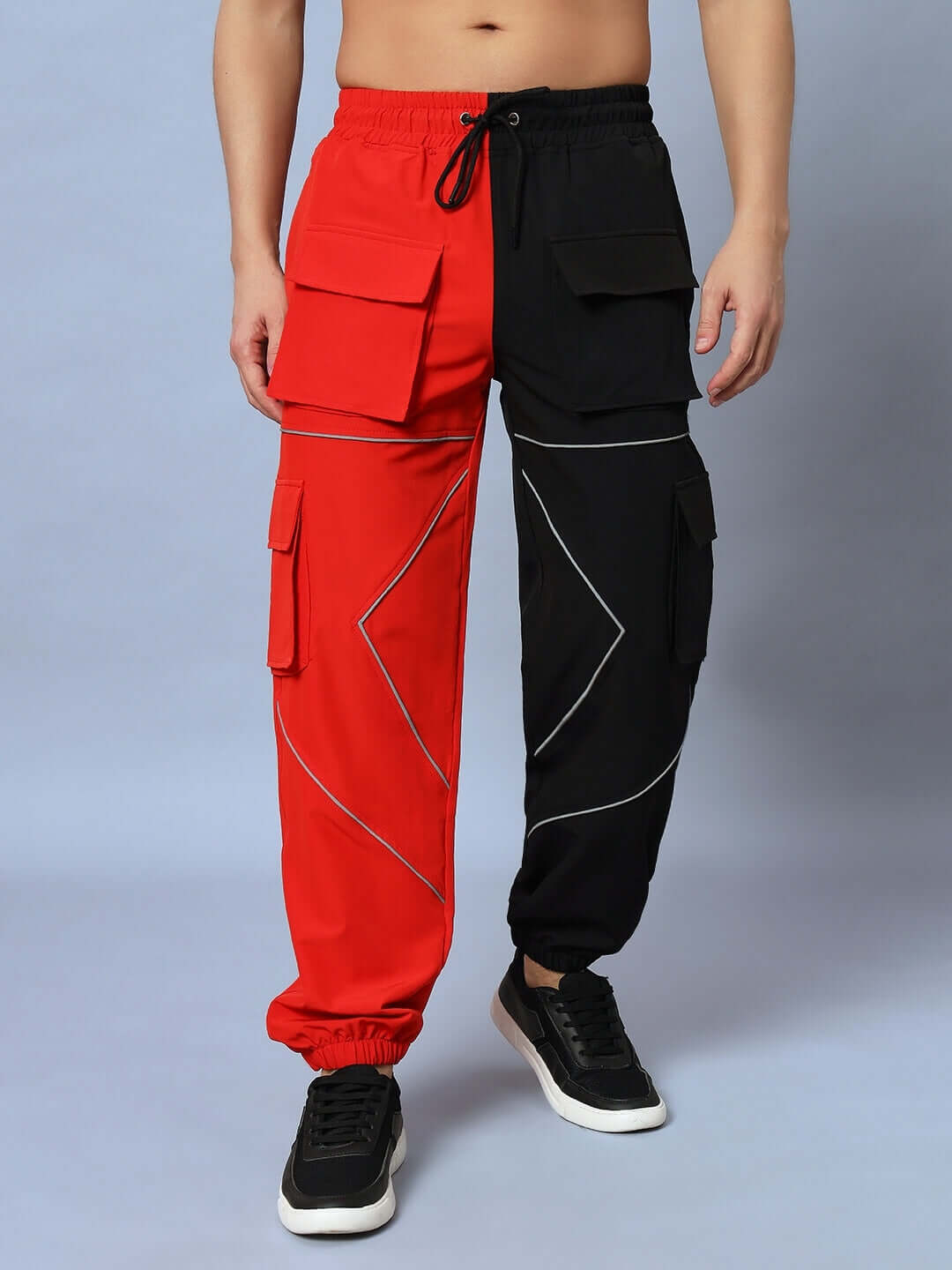 Red and black parachute cargo pants with pocket detailing and drawstring waist, perfect for a stylish and customizable fit.