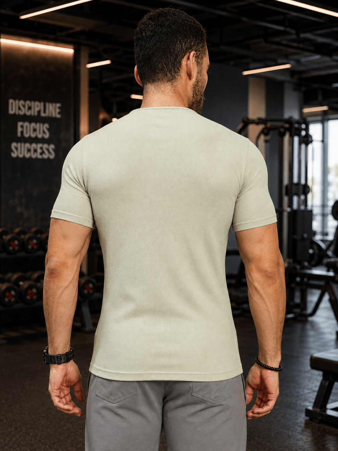 FROSTED FIT AGATE T-SHIRT SAGE GREEN displayed on a man from the back in a gym setting.