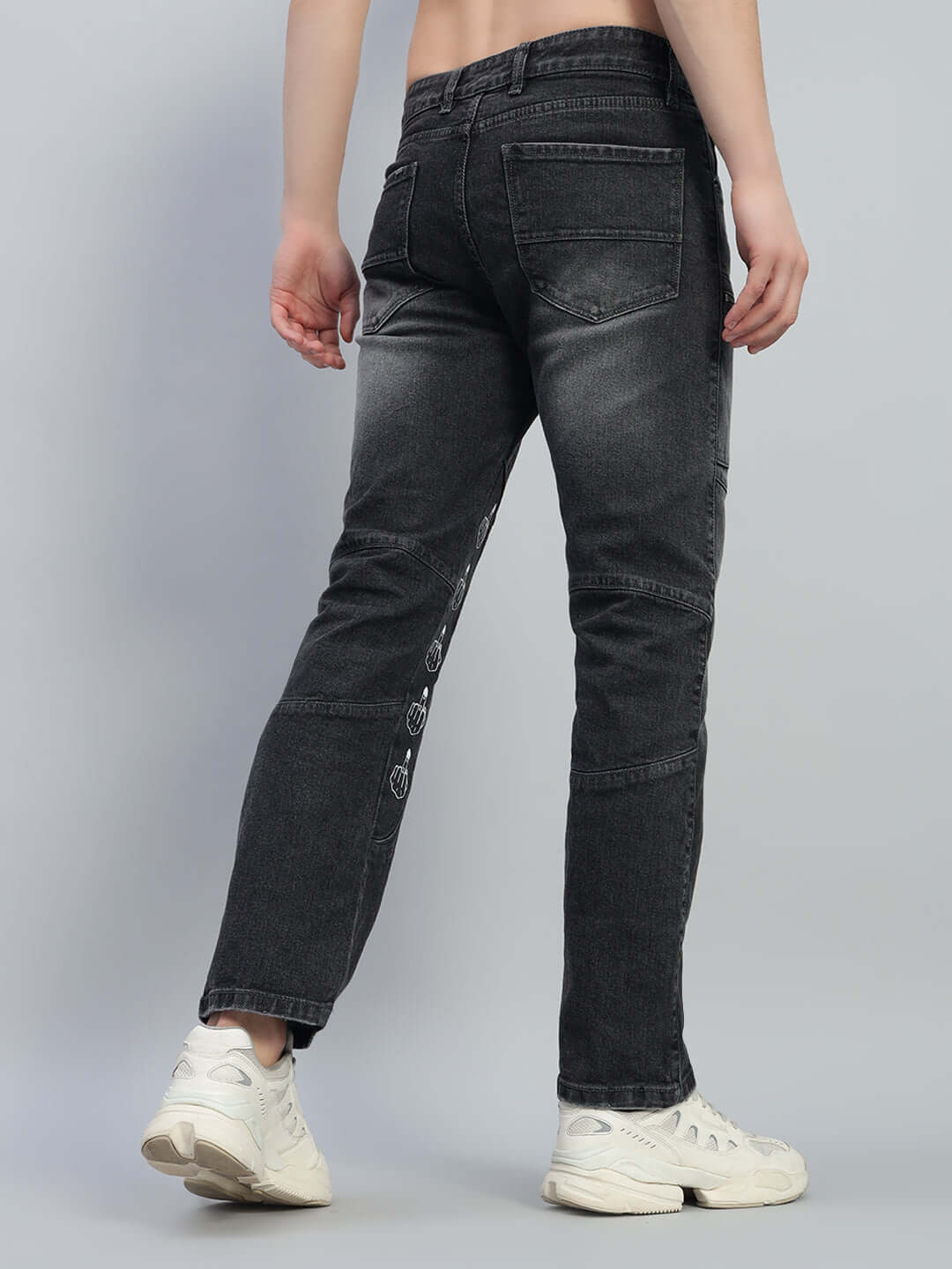 Back view of black regular fit denim jeans with custom fit option, worn with white sneakers, made to order by DUDS.