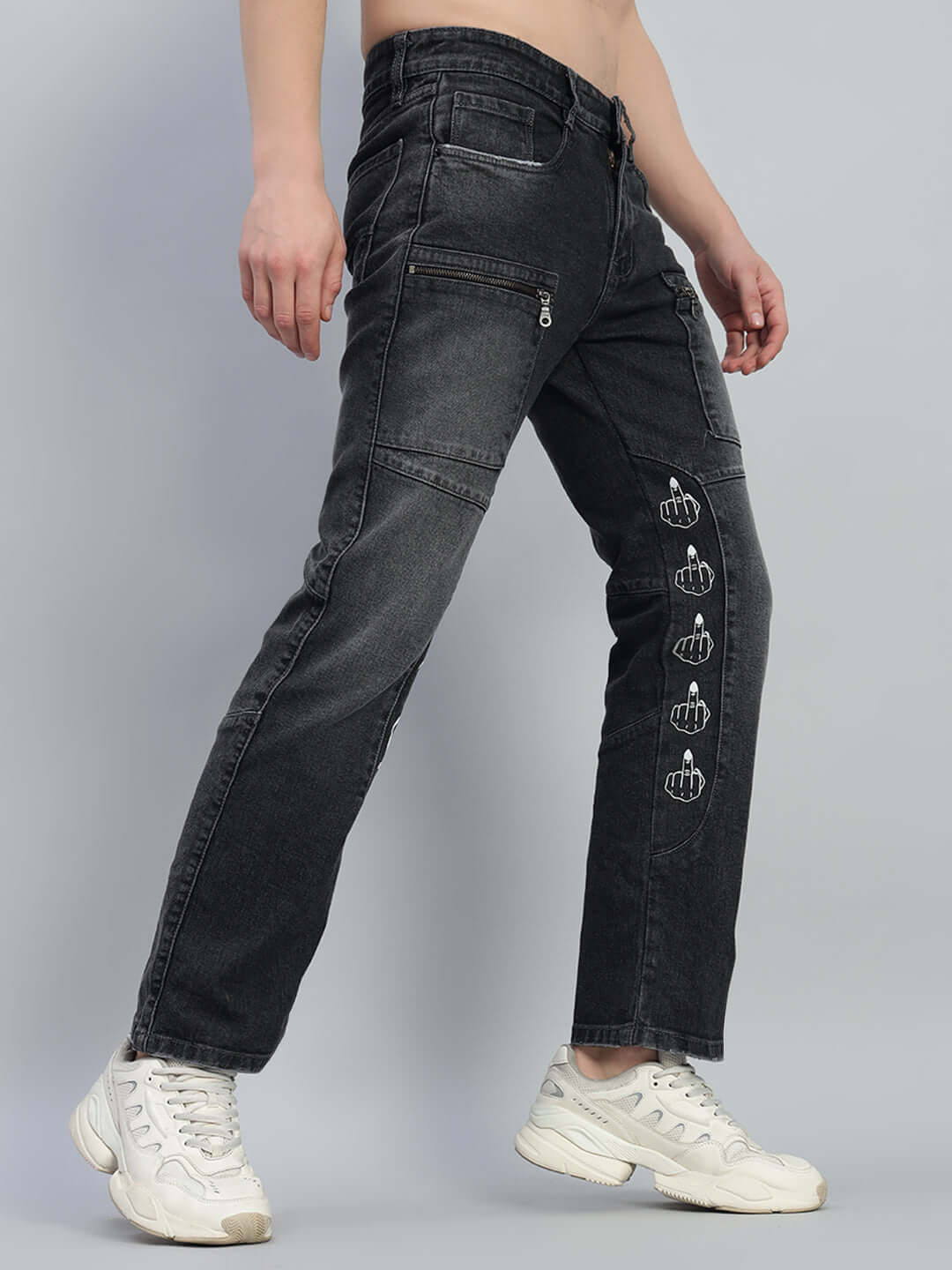 Person wearing black regular fit denim jeans with graphics, showcasing a stylish casual look. Available for custom fit orders.