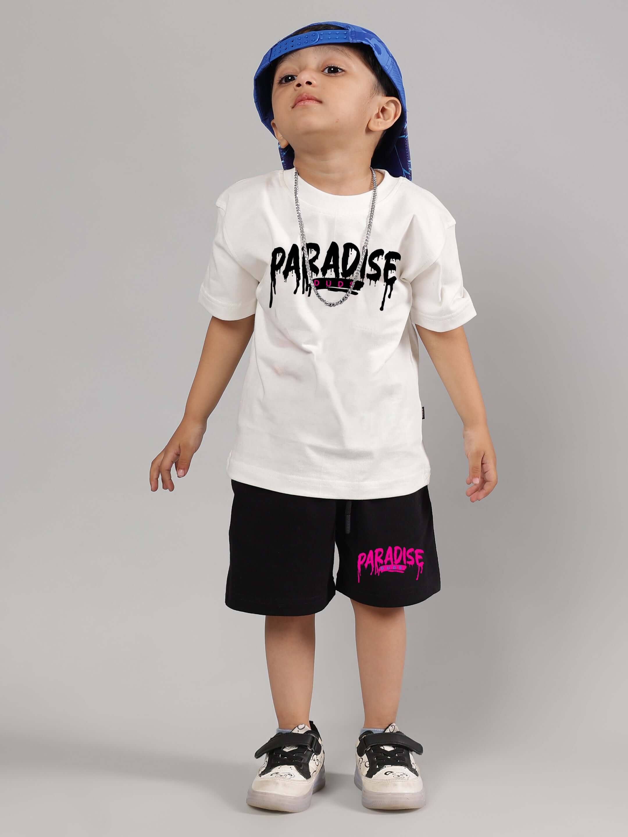 Child wearing Fulness Paradise Co-ord for Boys & Girls in Off White-Black by DUDS, featuring a trendy t-shirt and shorts set.