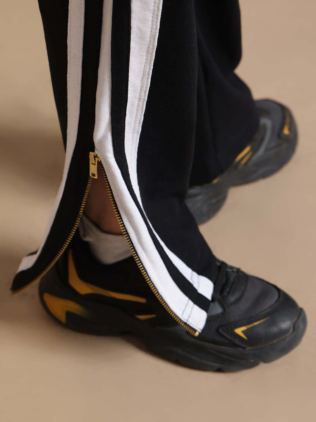 FUN BABE CO-ORD FOR BOYS GIRLS BLACK joggers with white stripes and zipper detail on black sneakers.