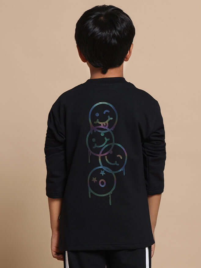 Child wearing black FUN BABE co-ord set with emoticon design on the back, suitable for boys and girls.