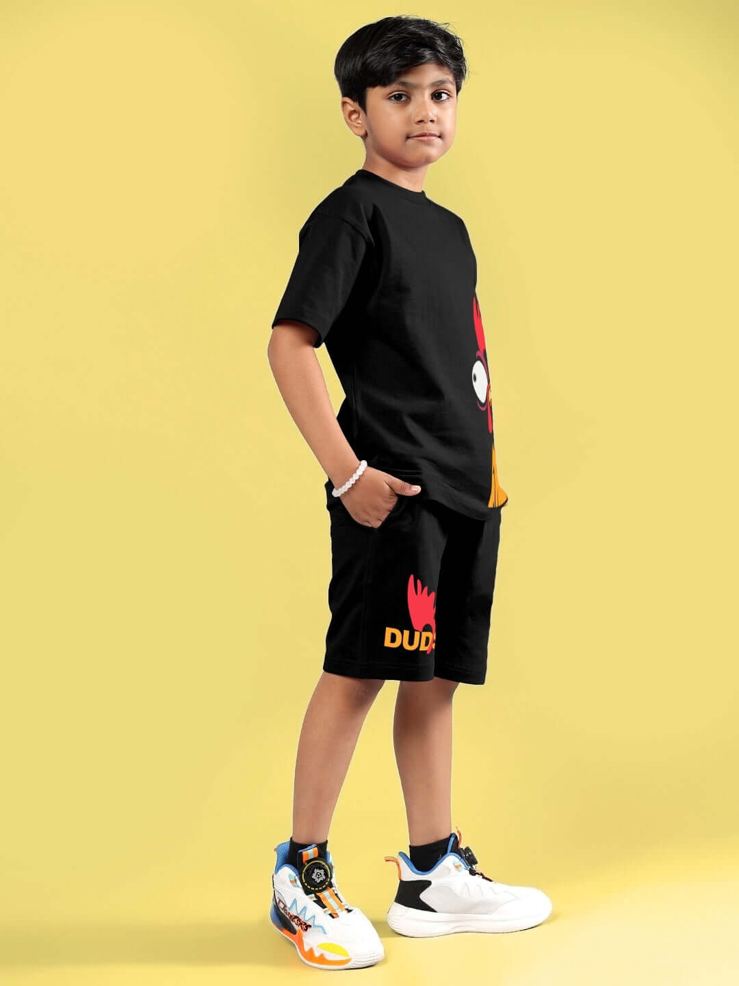 Child wearing FUNNY CHICKEN PRINTED CO-ORD FOR BOYS & GIRLS BLACK by DUDS, featuring a playful design, perfect for casual wear.