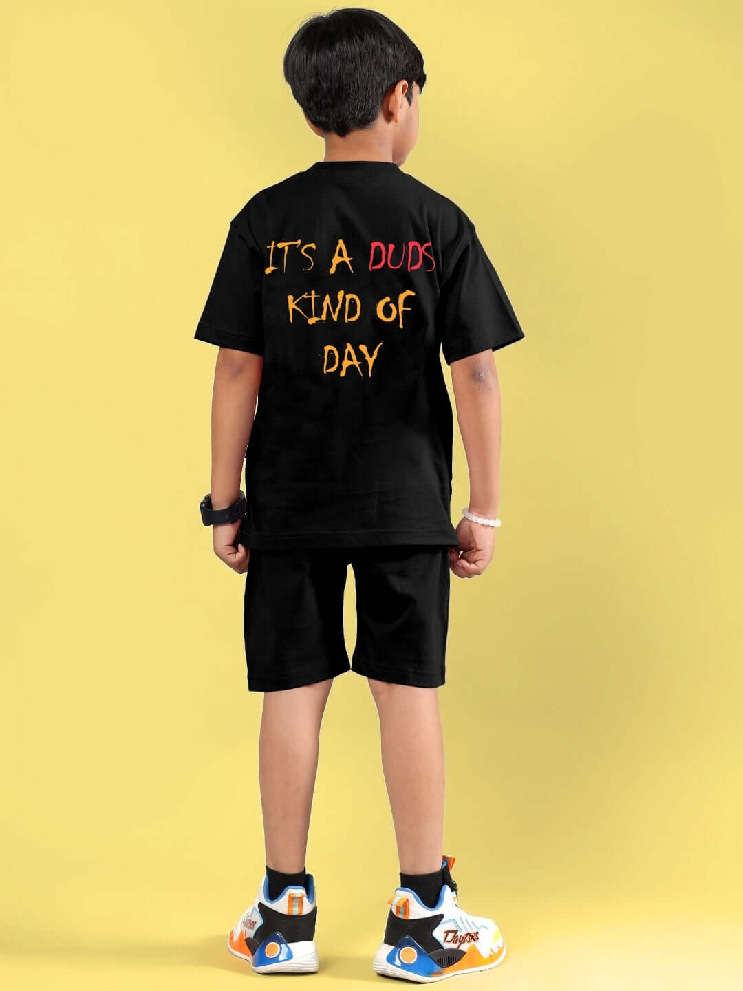 Child wearing black DUDS funny chicken printed co-ord set for boys & girls, showcasing a playful "It's a DUDS kind of day" message.