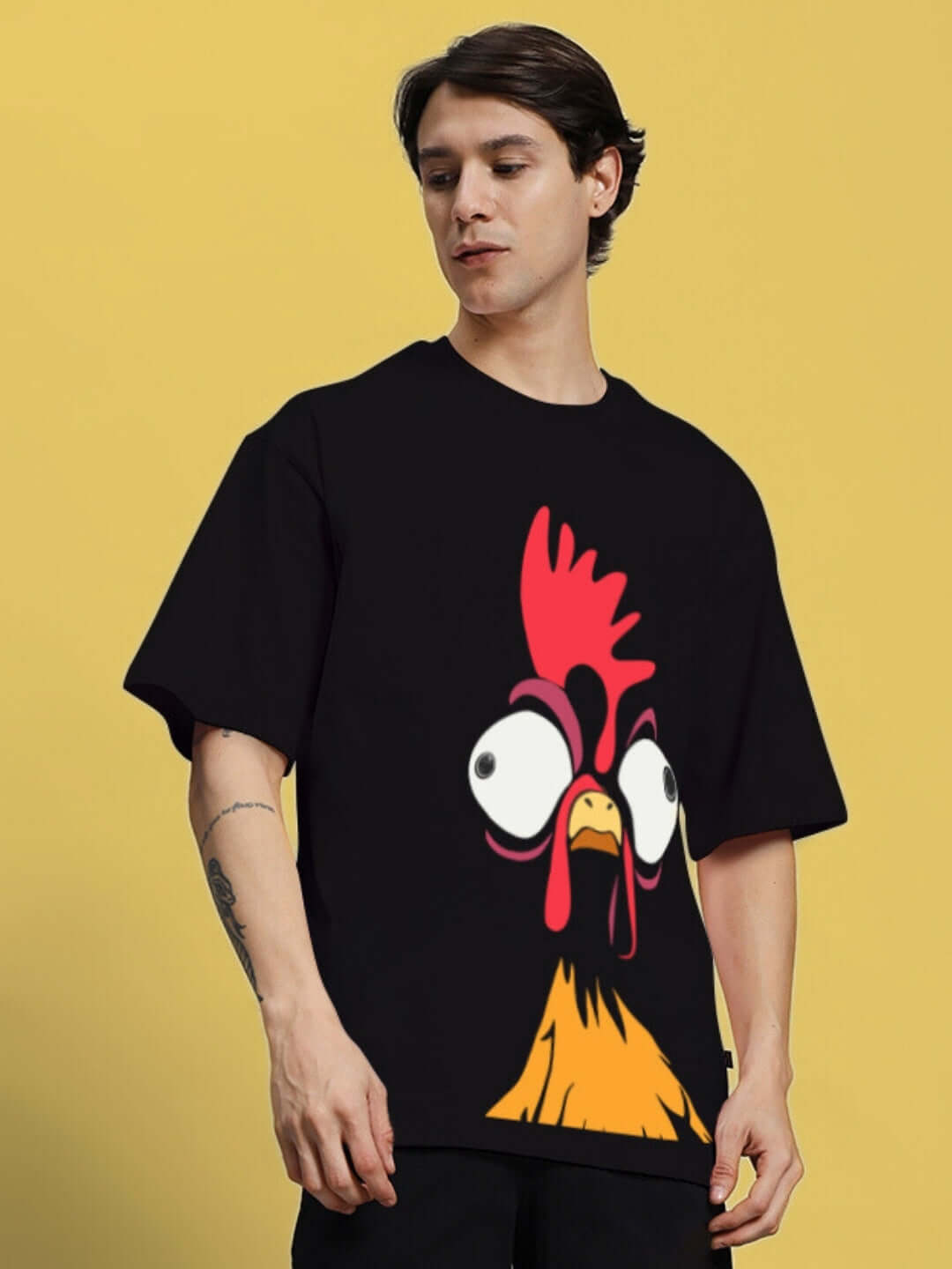 Man wearing FUNNY CHICKEN PRINTED OVERSIZED T-SHIRT BLACK, showcasing quirky chicken graphic on black tee; perfect for casual, humorous style.