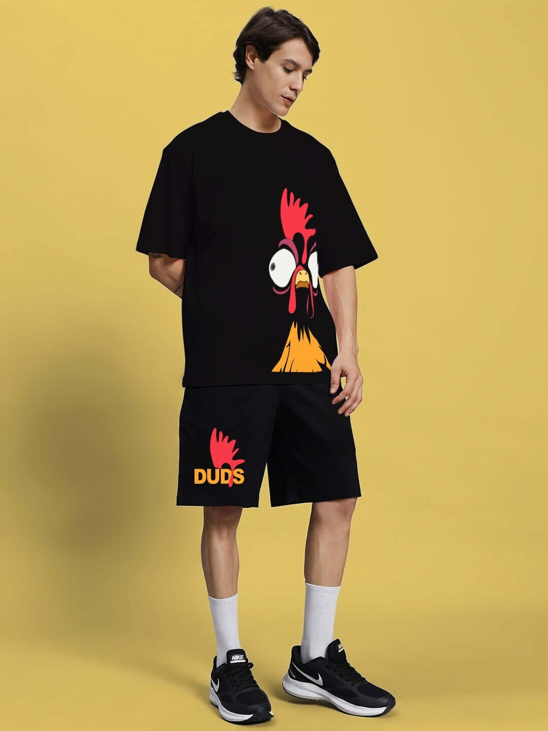 Model wearing FUNNY CHICKEN SUMMER CO-ORD SET BLACK with quirky print, casual summer fashion style.