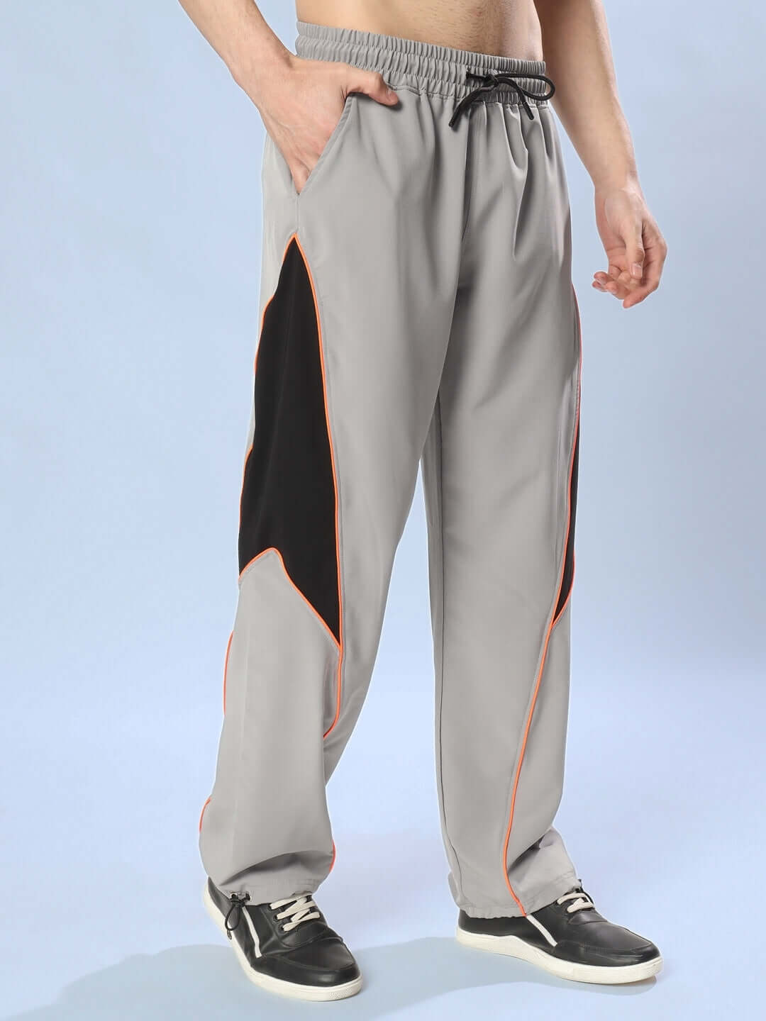 Grey relaxed fit cargo pants with orange trim, featuring customizable size options for a personalized fit.